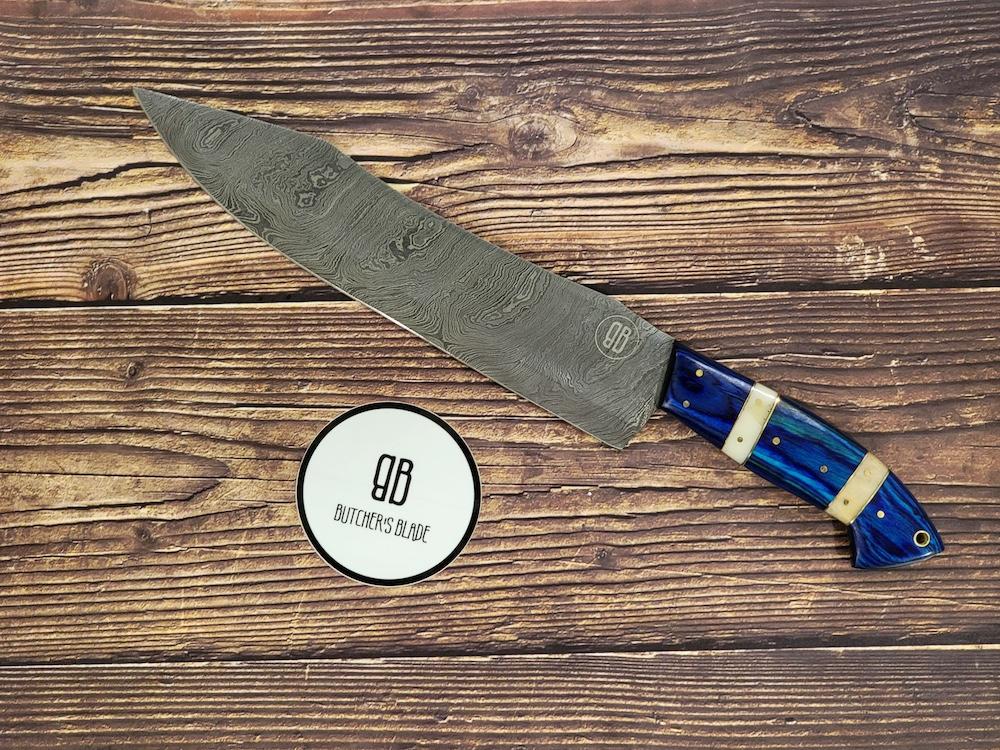 Butcher's Blade . This limited edition handmade 15" Damascus Slicing knife is part of our Summer 2021 Damascus series of knives. Each knife is handmade and no two handle are 100% identical, they are the same pattern and material but since they are made by hand there will be very slight variances if yo compare 2 side by side.  This Knife is made of 420 layers of High 149. Damascus steel with a 10" blade and 5" handle. Each knife come in a wooden storage box.