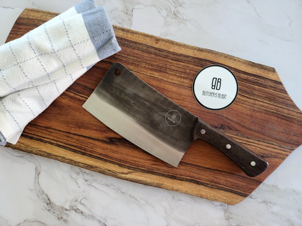 This classic Butcher's style cleaver by the Butcher's Blade, is big and solid knife that can chop or cut just about anything you can throw at it. It is heavy and makes cutting almost anything feel like slicing thru butter.  This classic looking beauty weighs in at right around 1lb