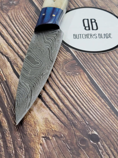 This limited edition handmade Pairing knife is part of the Butcher's Blade Summer 2021 Damascus series of knives. Each knife is handmade and no two handle are 100% identical, they are the same pattern and material but since they are made by hand there will be very slight variances if you compare 2 side by side.  This Knife is made of 420 layers of High Carbon Damascus steel with any 4.5" blade and 4.5" handle. Each knife come in a wooden storage box.